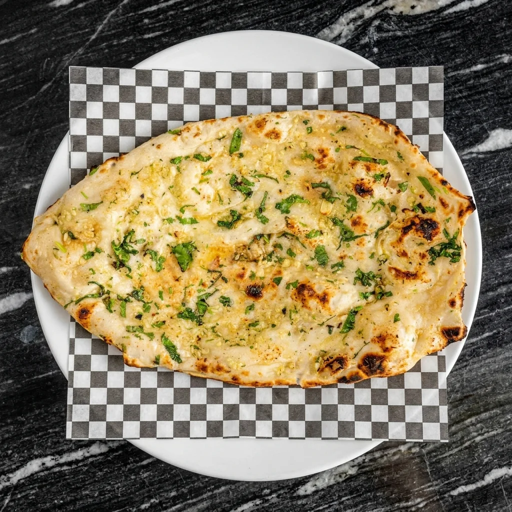 Freshly baked buttery Garlic Naan from the tandoor at Hyderabad Biryani House Vancouver